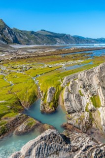 Landscape of the Flysch Basque Coast geopark in Zumaia with low seas with marine vegetation,