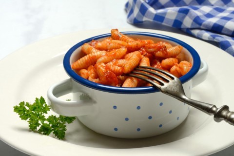 Malloreddus, Sardinian gnocchetti with tomato sauce in a bowl, traditional pasta variety from