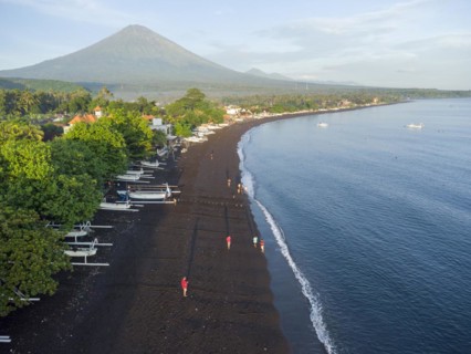 Fishermen loading fish from their outrigger boats in the morning on the black beach of Amed, Amed,