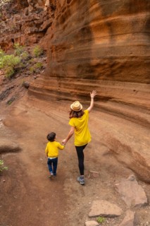 Family walking in the limestone canyon Barranco de las Vacas in Gran Canaria, Canary Islands