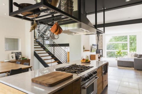 American walnut wood island with quartzite countertop and built-in gas stove in the kitchen inside