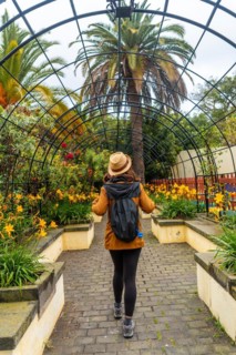 A woman walking through a beautiful botanical garden, a sustainable tourism concept in Arucas, Gran