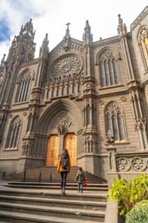 A mother with her son visiting the Church of San Juan Bautista, Arucas Cathedral, Gran Canaria,
