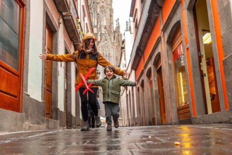 A mother playing with her son on a street near the Church of San Juan Bautista, Arucas Cathedral,