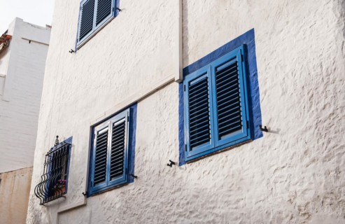 Closed blue shutters on a house in Sitges, Spain, Europe