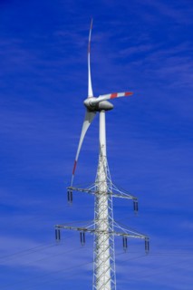 Electricity pylon with high-voltage lines and wind turbine at the Avacon substation Helmstedt,