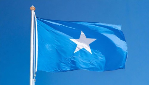 The flag of Somalia, fluttering in the wind, isolated, against the blue sky
