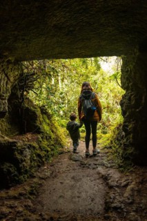 A child and his mother in a cave in the Laurisilva forest of Los tilos de Moya, Gran Canaria