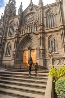 A mother with her son visiting the Church of San Juan Bautista, Arucas Cathedral, Gran Canaria,