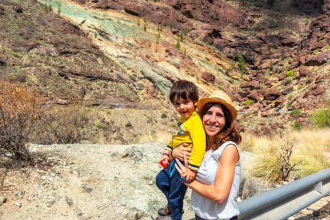 Family of mother and son enjoying at the Natural Monument Azulejos de Veneguera or Rainbow Rocks in