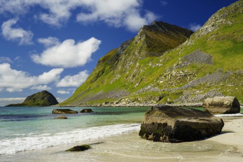Landscape with sea at the sandy beach of Haukland (Hauklandstranda) with the mountain Veggen. Some