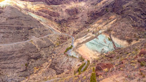 Aerial view of the Azulejos de Veneguera or Rainbow Rocks Natural Monument in Mogan, Gran Canaria
