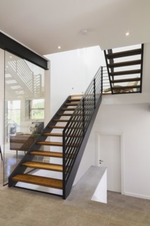 American walnut wood and black powder coated cold rolled steel stairs inside modern cube style