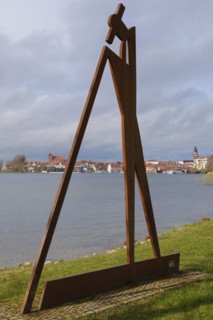 The raftsman, sculpture by Roman Peter, view of Waren with St Georgen's Church and St Mary's