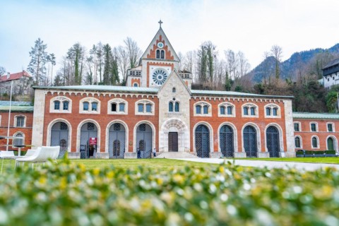 Old salt worksWide-angle shot of a Gothic church with brick facade in front of a hilly landscape,