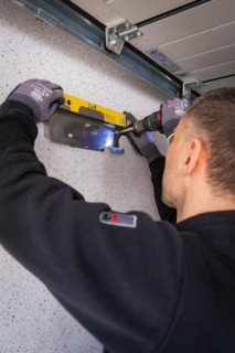 A craftsman uses a spirit level for precise alignment work, solar systems construction, crafts,