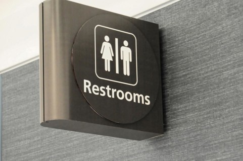 AUGUSTO C. SANDINO Airport, Managua, Nicaragua, sign for a unisex toilet on a wall in the airport,