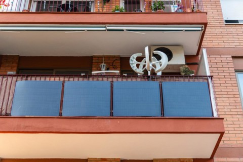 Balcony power plant and mini wind turbine on a balcony of a high-rise building in Barcelona, Spain,