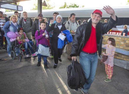 Syrian refugees have arrived at Schoenefeld station on a special train. They are then taken by bus