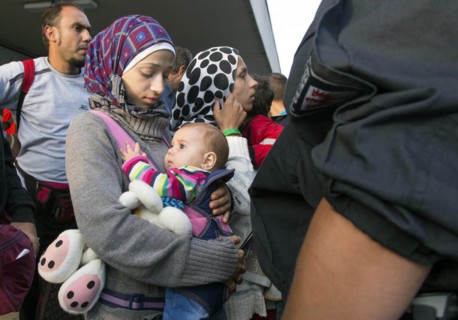Syrian refugees have arrived at Schoenefeld station on a special train. They are then taken by bus