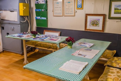 Interior of saloon with magazines om tables inside battleship on display at Unification Park in