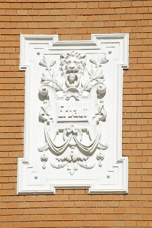 White, decorated plaque on a brick wall of an old Bremen house from the Wilhelminian era, Bremen,