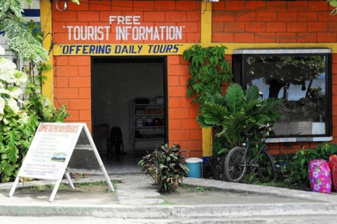Ometepe Island, Nicaragua, A red building with signs for tourist information and daily tours,
