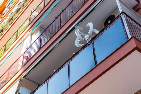 Balcony power plant and mini wind turbine on a balcony of a high-rise building in Barcelona, Spain,