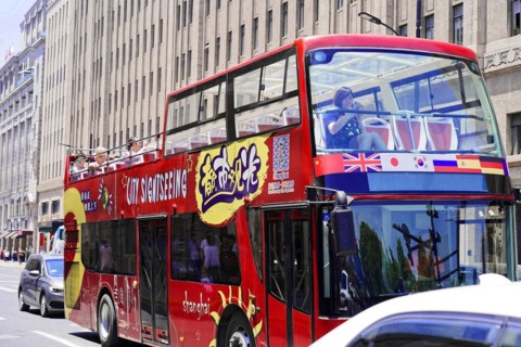 Shanghai, Sightseeing double-decker bus with colourful design drives through the city, Shanghai,