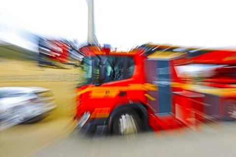 Fire engine in motion with strong blur, suggesting dynamics