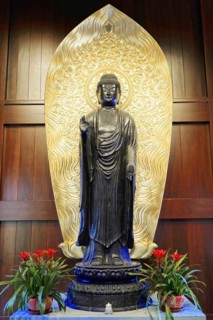 Jade Buddha Temple, Shanghai, Large Buddha statue in front of a gold-decorated background,