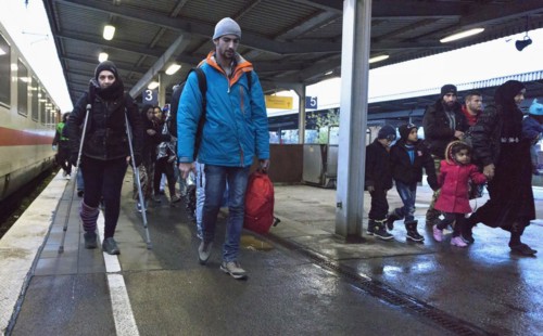 Refugees have arrived at Schoenefeld station on an IC train. They are then taken by bus to