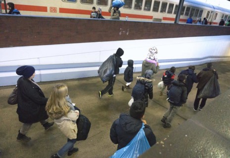 Refugees have arrived at Schoenefeld station on an IC train. They are then taken by bus to