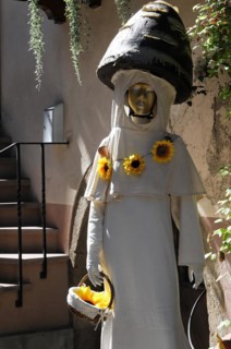 Eguisheim, Alsace, France, Europe, A statue of a woman in a white robe, decorated with sunflowers,
