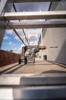A cordless screwdriver lying on a wooden floor on a construction site, Solar systems construction,