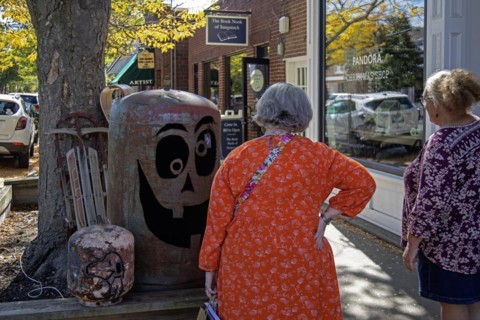 Saugatuck, Michigan, Tourists view a piece of artwork in Saugatuck, a town on the shore of Lake