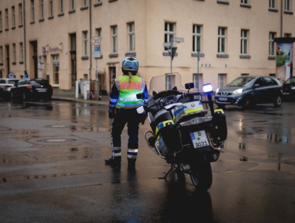 Policewoman with motorbike blocks road, taken during a demonstration in Berlin, 19/04/2024
