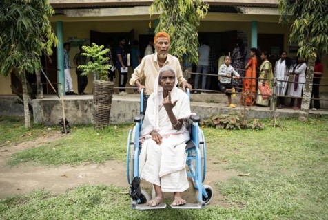 BOKAKHAT, INDIA, APRIL 19: A elderly woman in wheelchair show her marked finger after casting vote