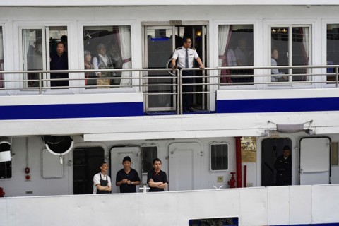 Chongqing, Chongqing Province, China, People standing at the railing of a ship, probably crew