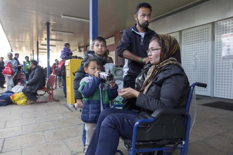 Syrian refugees have arrived at Schoenefeld station on a special train. They are then taken by bus