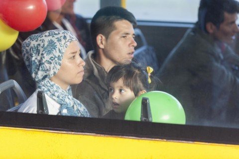 Syrian refugees have arrived at Schoenefeld station on a special train. They are then taken by bus