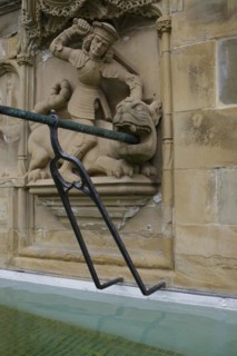 Dragon slayer motif on the fish fountain, dragon, sword, fountain, market fountain, old town,
