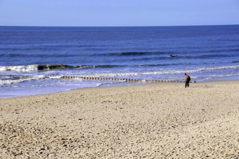 Westerland, Sylt, Schleswig-Holstein, Germany, Europe, Person walking along the edge of the sea