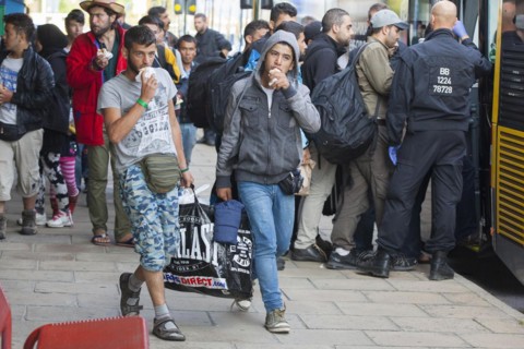 Syrian refugees have arrived at Schoenefeld station on a special train. They are then taken by bus