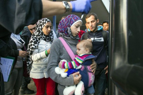 Syrian refugees have arrived at Schoenefeld station on a special train. They are then taken by bus