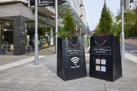 Planters as oversized shopping bags with cord on the Am Wall shopping street in Bremen, Hanseatic