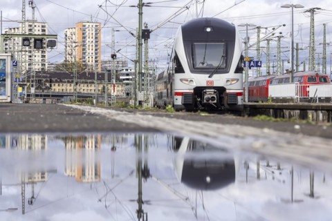 Stuttgart main station with track apron and arriving and departing trains. InterCity, Stadler KISS