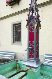 Historic fountain in neo-Gothic style on Postplatz in the old town centre of Wangen im Allgaeu,