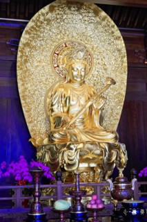 Jade Buddha Temple, Shanghai, Golden Buddha statue in sitting pose, surrounded by religious