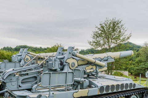 Side view of gun and controls of military tank on display in public park in Nonsan, South Korea,